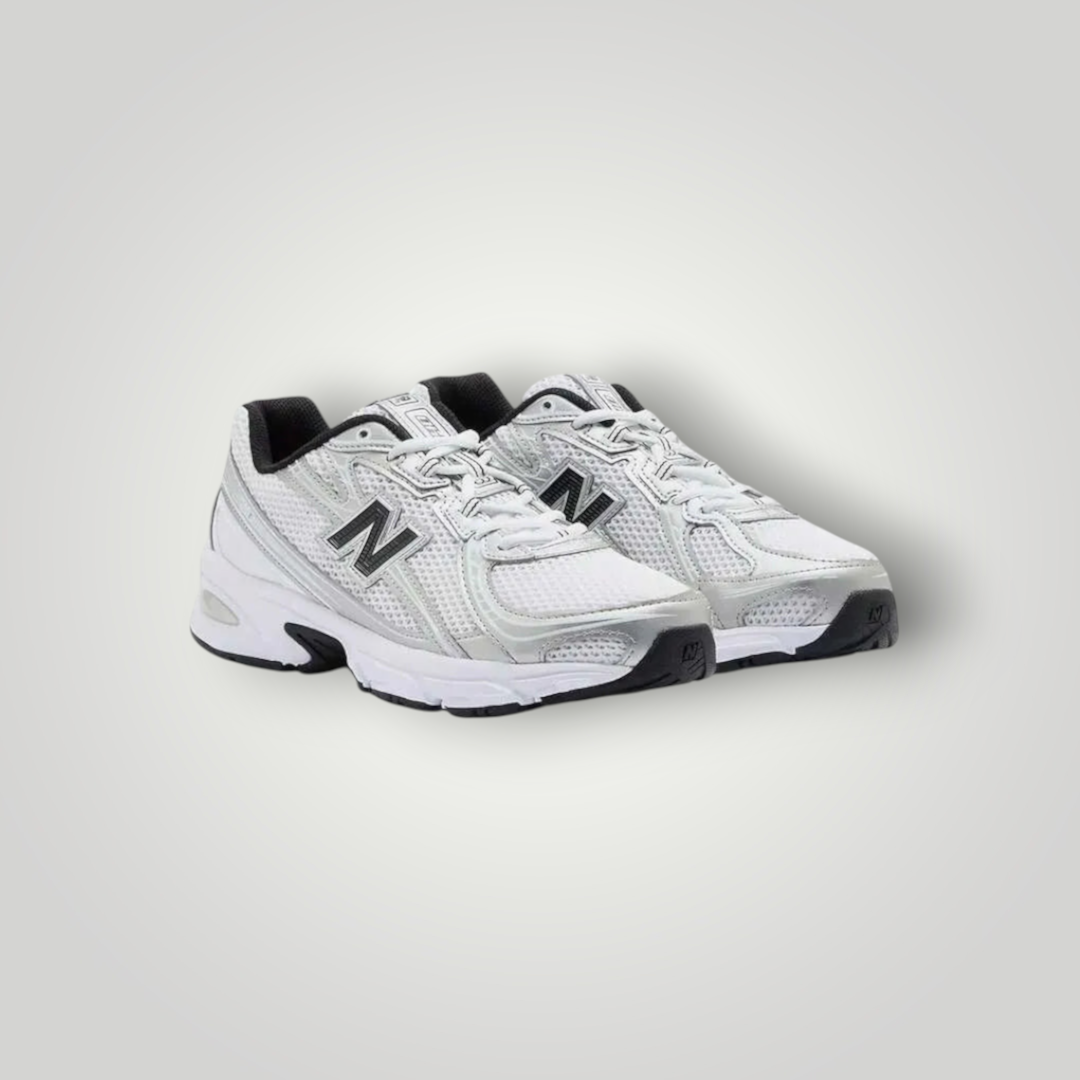 NDO Clothing New Balance 740 Sneaker in Weiss und Silber mit Mesh-Obermaterial, Schnürung und Abzorb-Dämpfung.