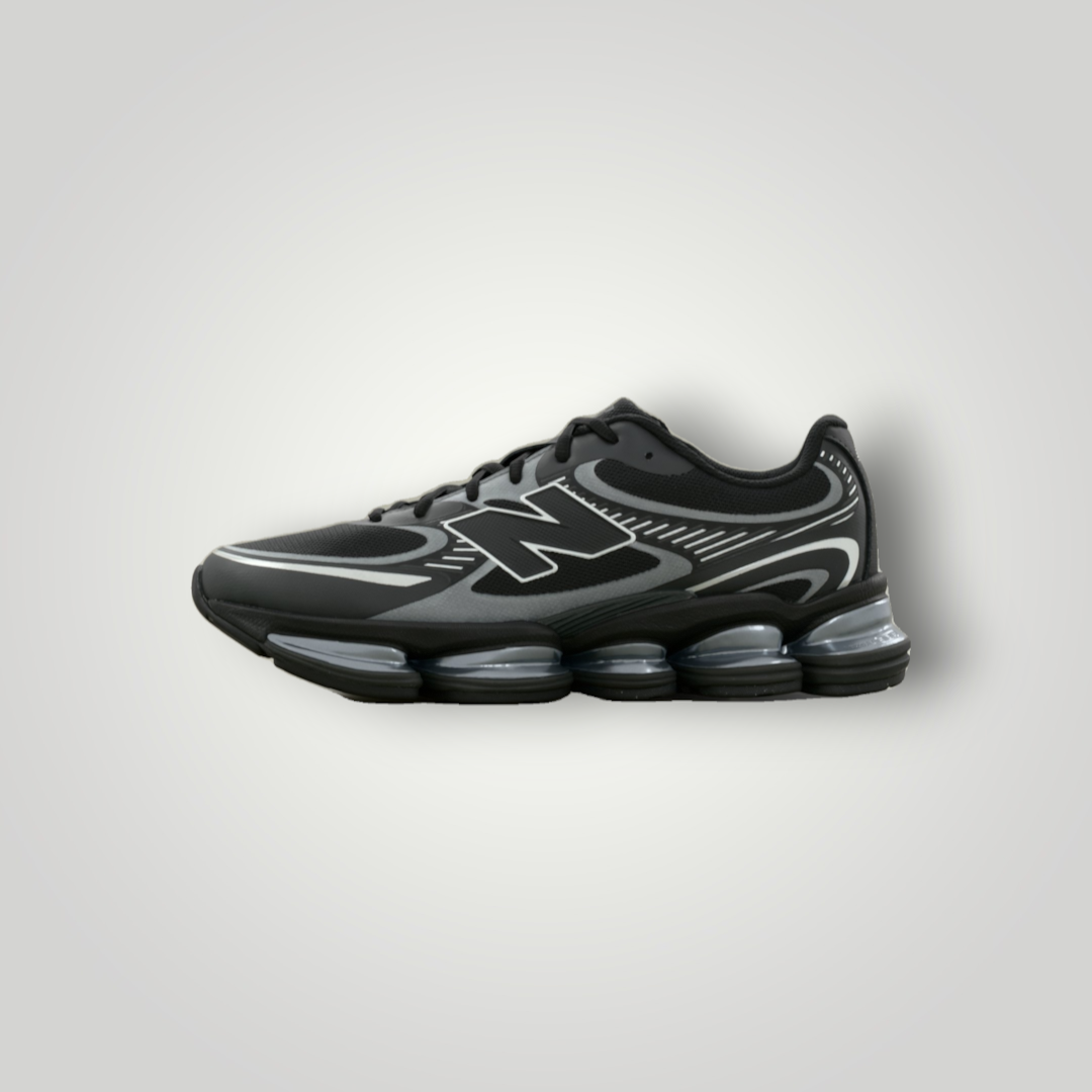 NDO Clothing New Balance U2000 Sneaker in Schwarz mit silbernen Metallic-Akzenten, Mesh-Obermaterial und Dämpfungssohle.